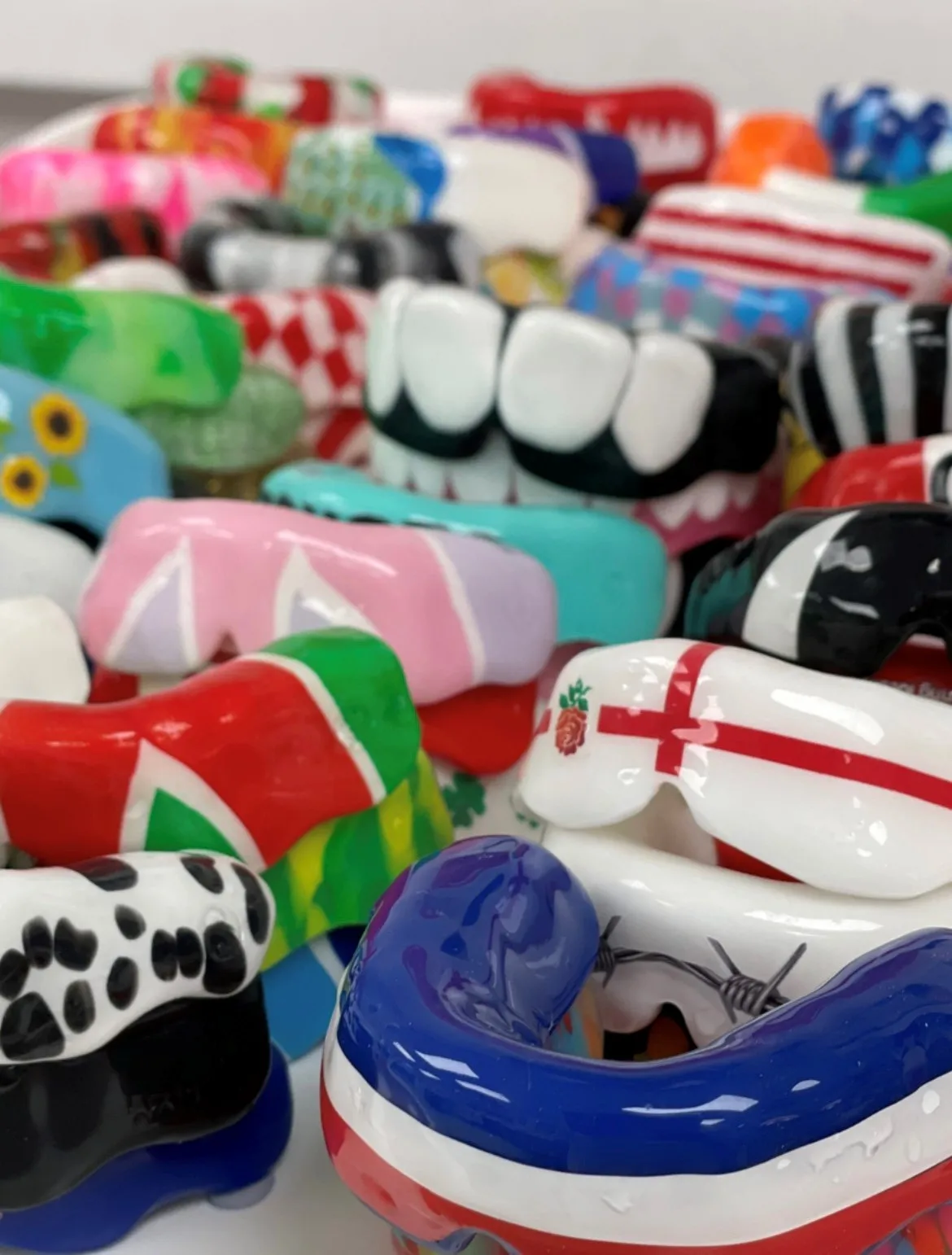 A tray of brightly coloured custom-fitted sports gumshields made in our lab