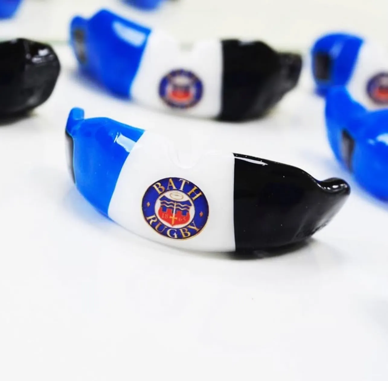 Custom-fitted team gumshields in club colours with a club crest set into the front