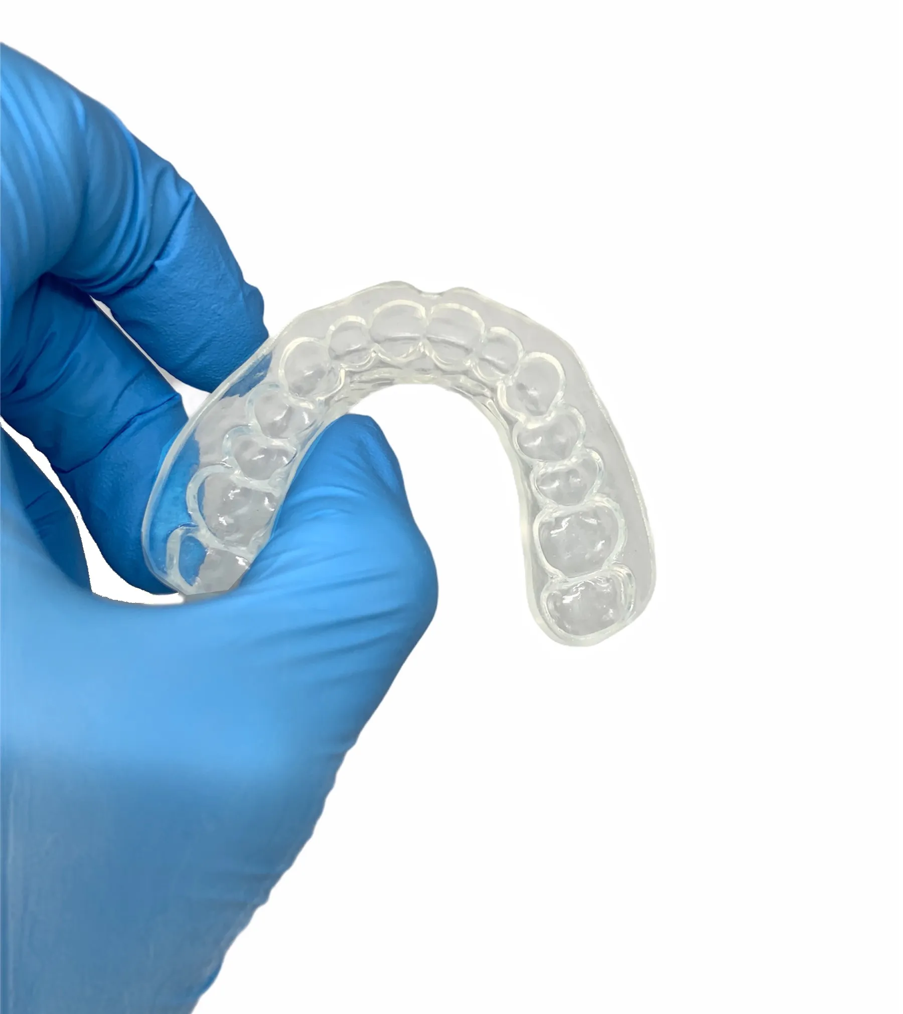 A clear custom whitening tray held in our lab