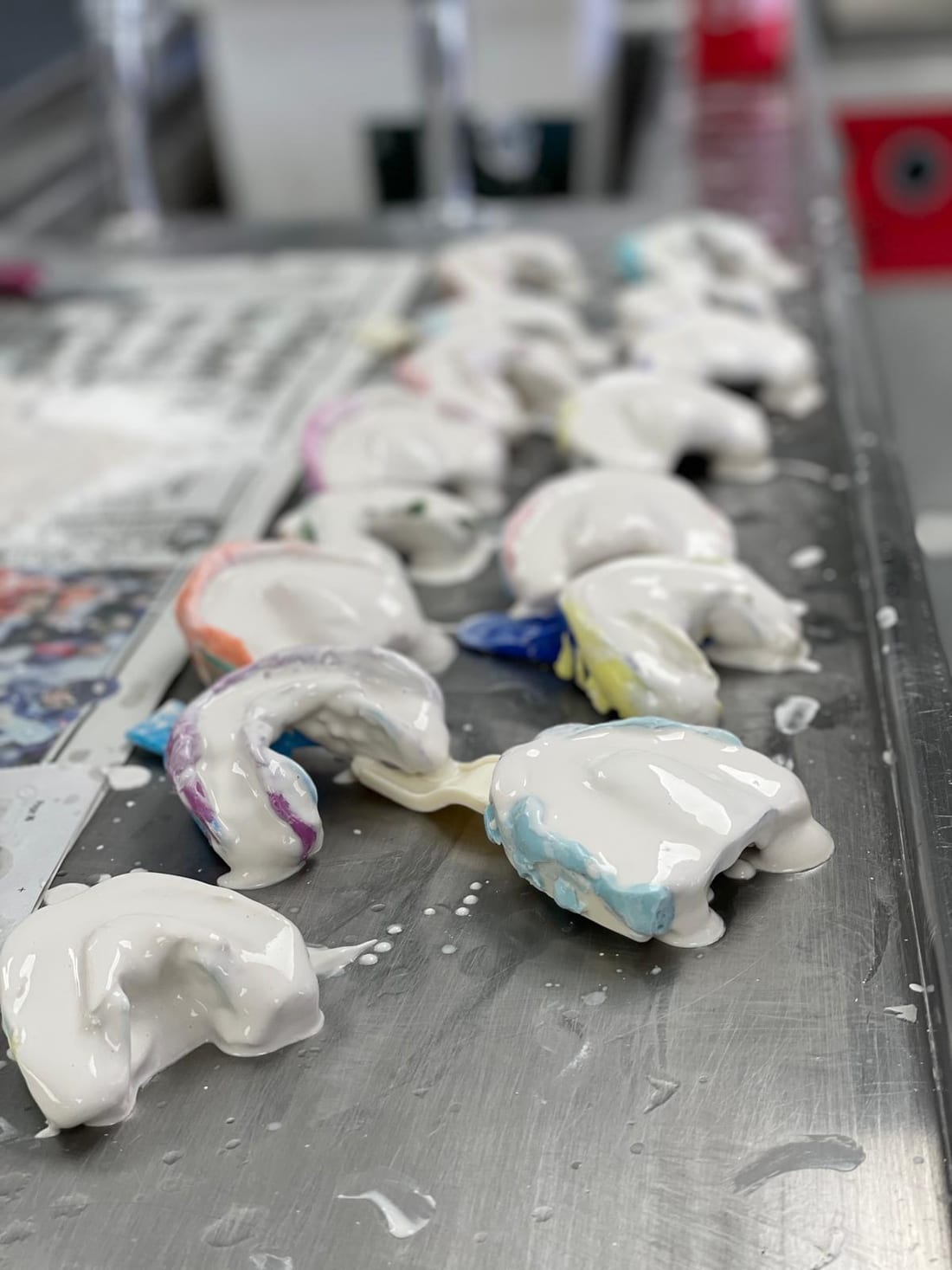 Traditional alginate and silicone dental impressions being disinfected on the bench at Bridge Dental Laboratory